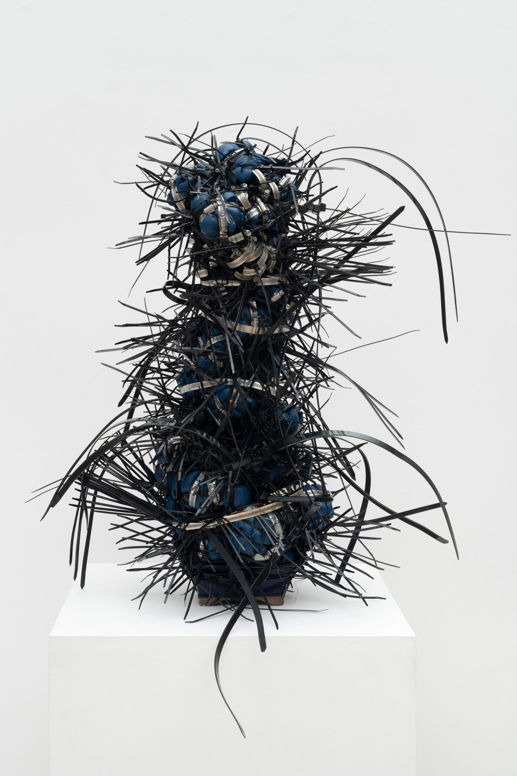 Ramekon O'Arwisters<br><em>Black & Blue #8</em>, 2025<br>Leather, fabric, metal, and pottery<br>36 x 17 x 14 inches / 91.4 x 43.2 x 35.6 cm