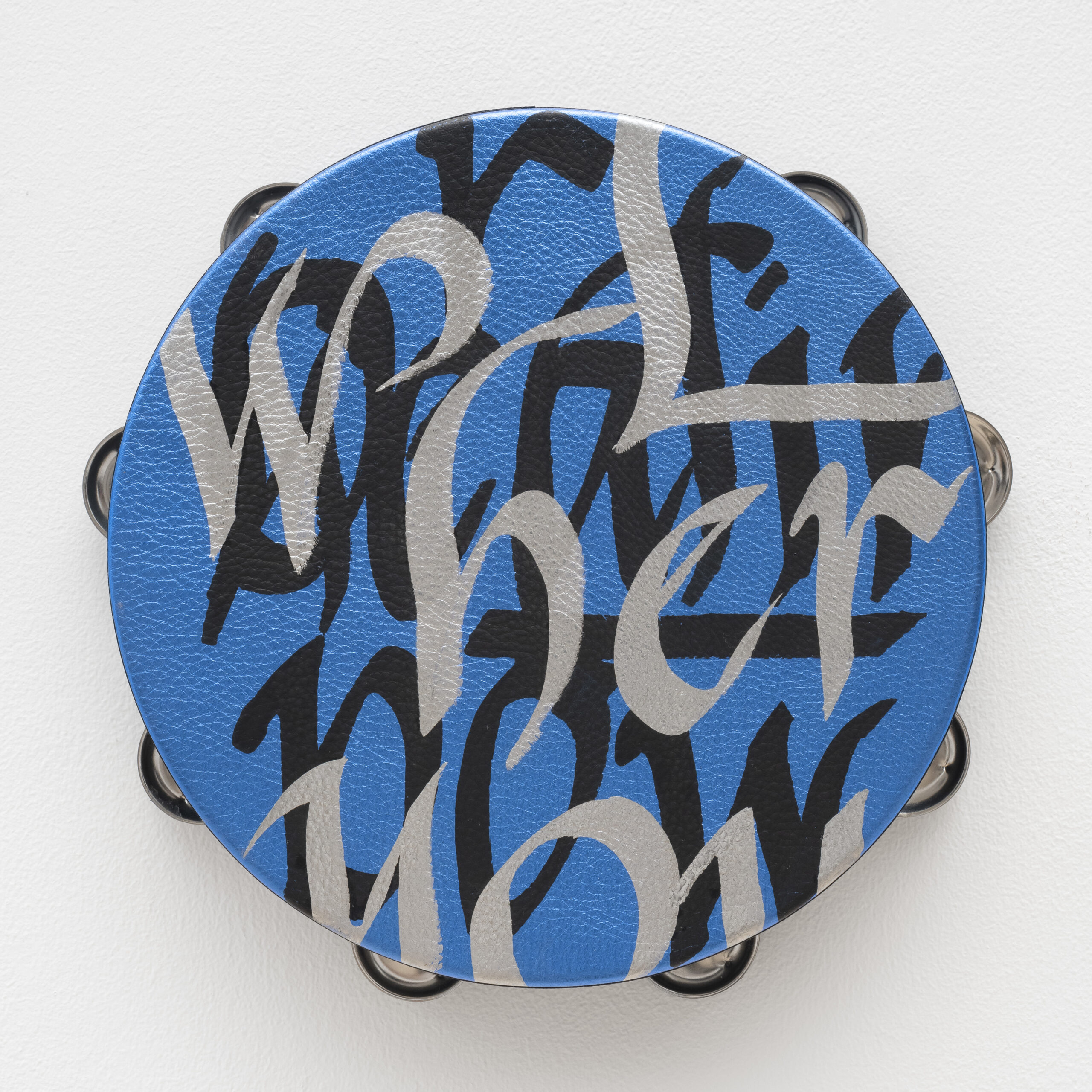 Lava Thomas<br><em>Brighten the Corner</em>, 2025<br>Altered tambourines, acrylic calligraphy on metallic leather, acrylic disks, and grosgrain ribbon<br>11 x 11 x 2 inches / 27.9 x 27.9 x 5.1 cm