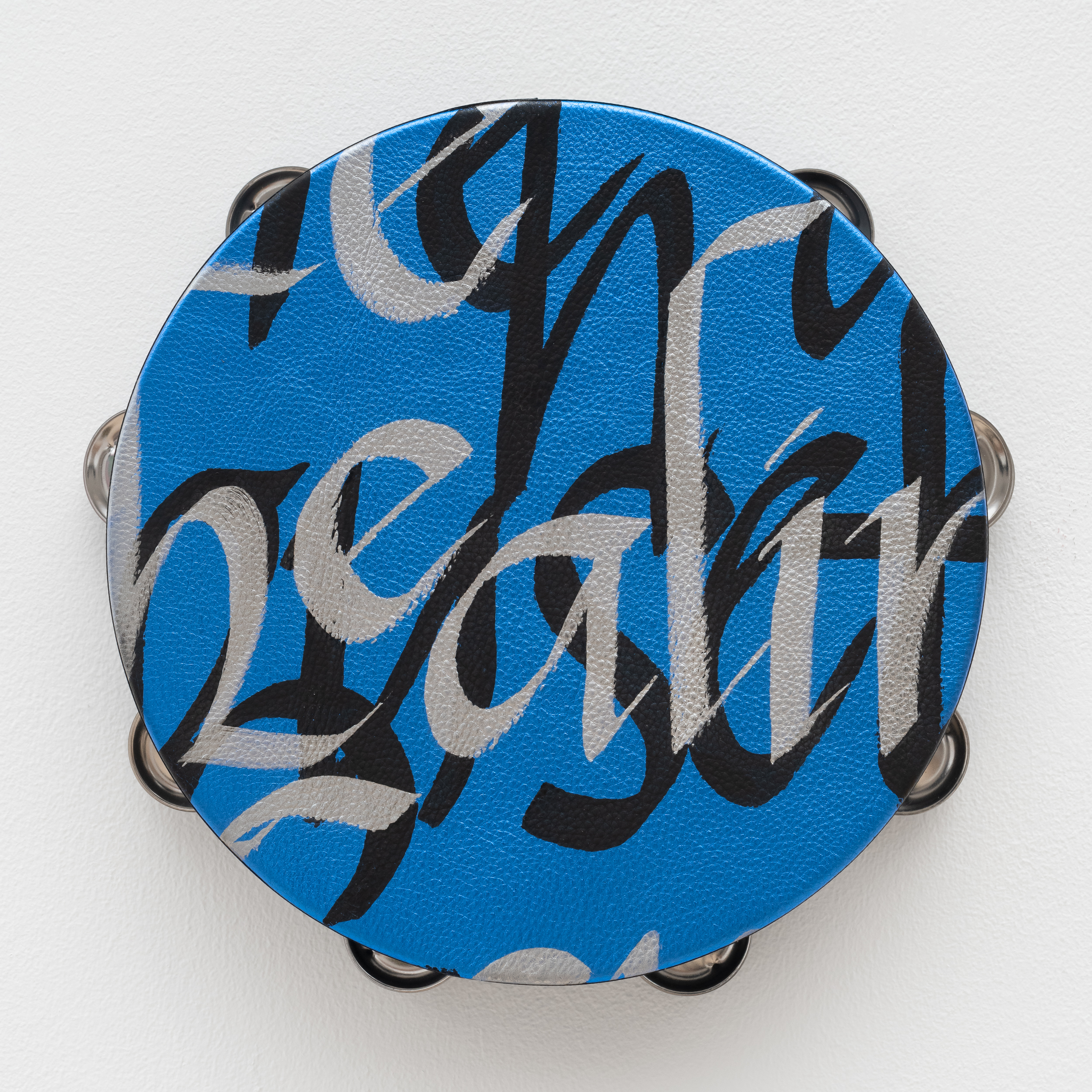 <p>Lava Thomas<br /><em>Healing Power</em>, 2025<br />Altered tambourines, acrylic calligraphy on metallic leather, acrylic disks, and grosgrain ribbon<br />11 x 11 x 2 inches / 27.9 x 27.9 x 5.1 cm</p>
