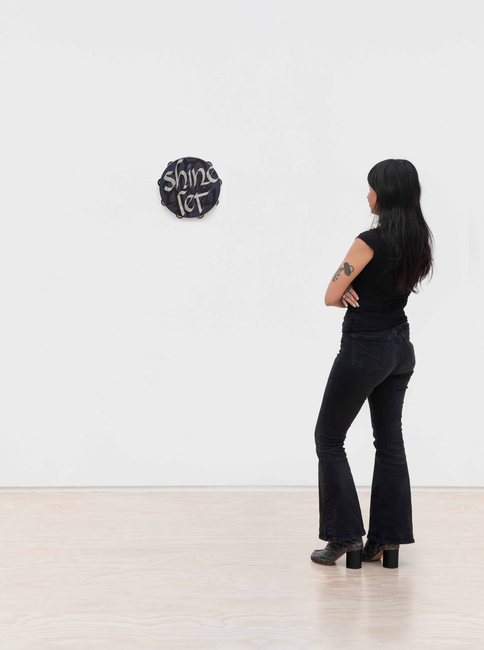 <p>Lava Thomas<br /><em>Let it Shine</em>, 2025<br />Altered tambourines, acrylic calligraphy on metallic leather, acrylic disks, and grosgrain ribbon<br />Scale view</p>
