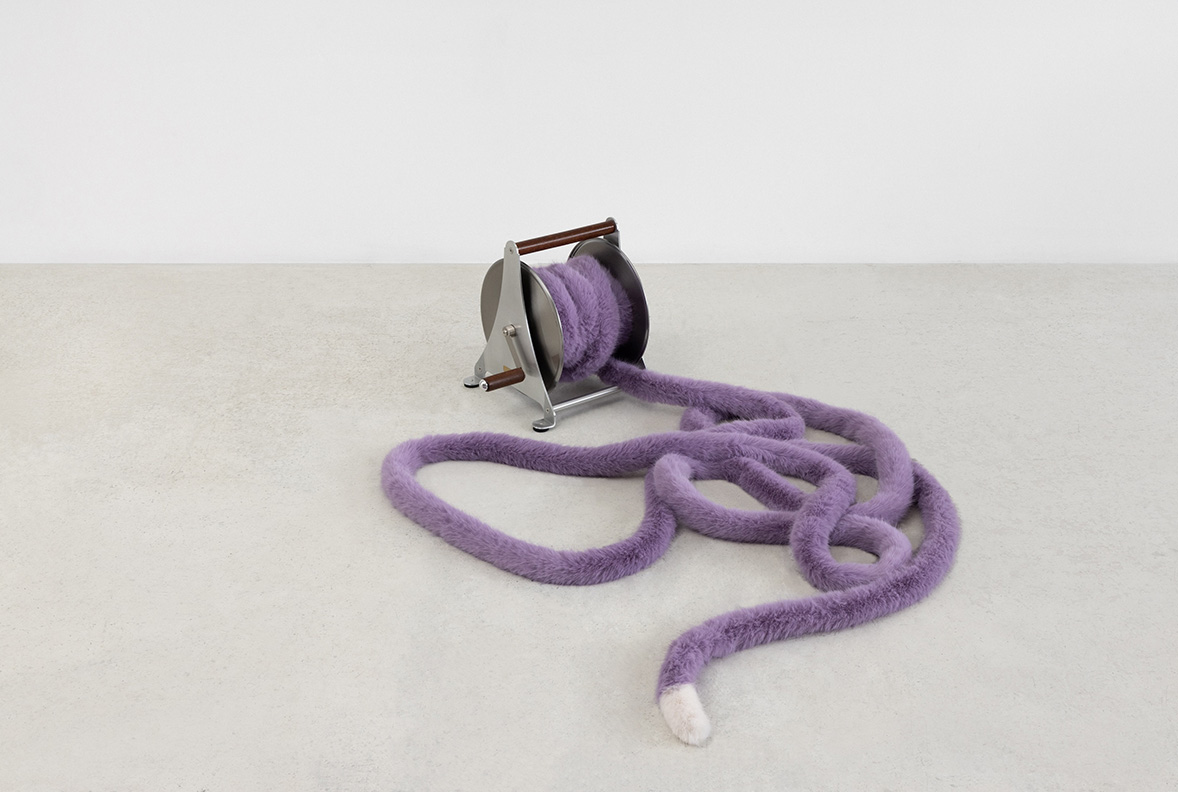 Nicole Wermers<br><em>Domestic Tail (purple, 13 metres)</em>, 2026<br>Stainless steel hose wheel with wooden handles and a hand sewn faux fur tail with polyester filling<br>19 1/4 x 15 3/4 x 19 1/4 inches / 49 x 40 x 49 cm