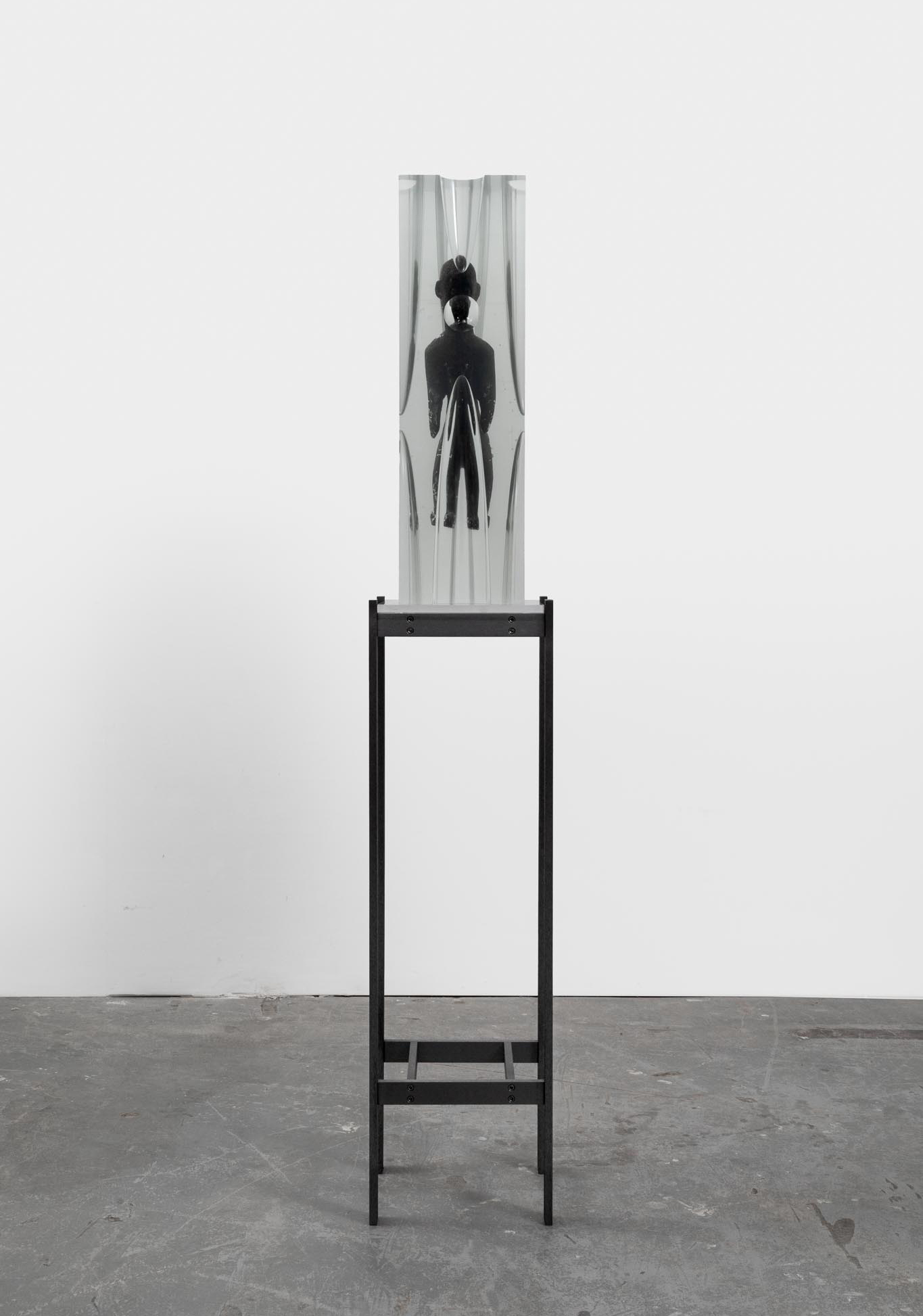 Matthew Angelo Harrison<br><em>Voices Return</em>, 2026<br>African wood sculpture, resin, plexiglass, and aluminum<br>67 1/8 x 11 3/4 x 10 1/4 inches / 170.5 x 29.8 x 26 cm